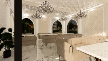 Elegant dining room with chandeliers and beige sofas.