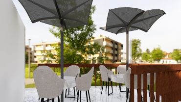 Outdoor patio seating with umbrellas and marble tables.