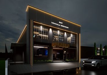 Modern brewery building illuminated at night.