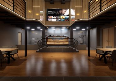 Modern cinema-style interior with a large screen and seating area.