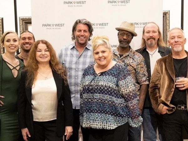 Group photo of eight people smiling at a Park West event in Las Vegas.