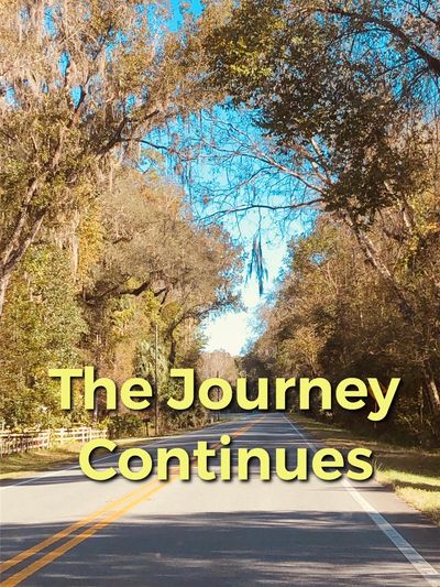 Open road under a bright sky with 'The Journey Continues' text.