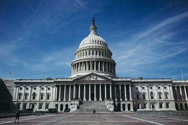 The United States Capitol building under a clear blue sky.