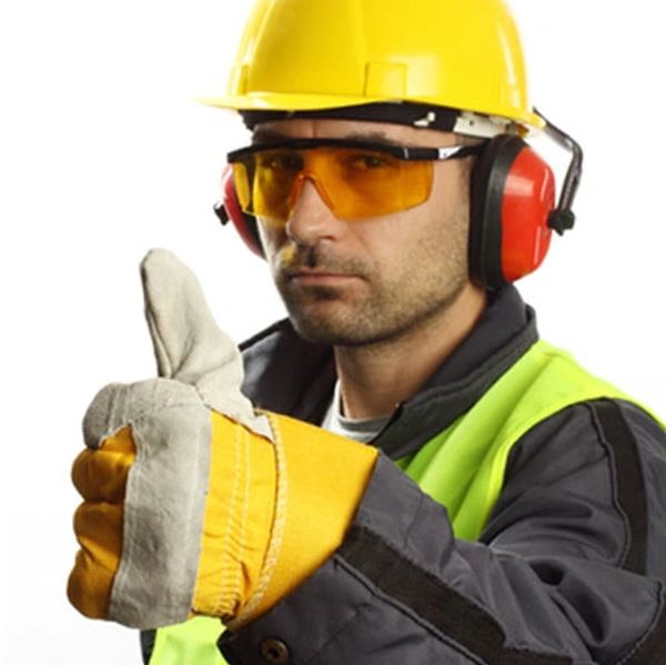Industrial Worker with Protective leather Gloves, Earmuffs, amber safety glasses wearing a yellow ha