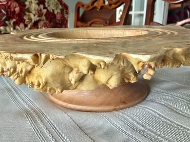 Ornate wooden stand with natural edge design.