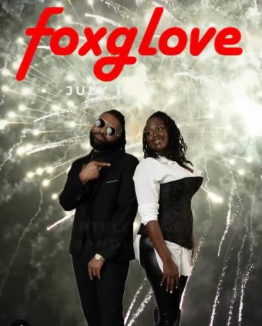 Two people posing in front of fireworks with "foxglove" text.