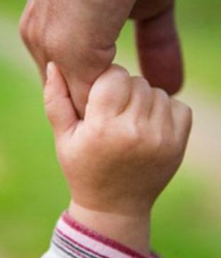 Adult hand holding a child's hand
