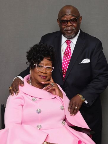 Elegant couple dressed in formal attire posing for a portrait.