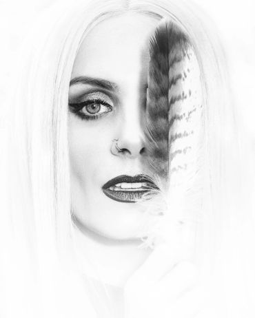 Black and white portrait with a feather covering half the face.