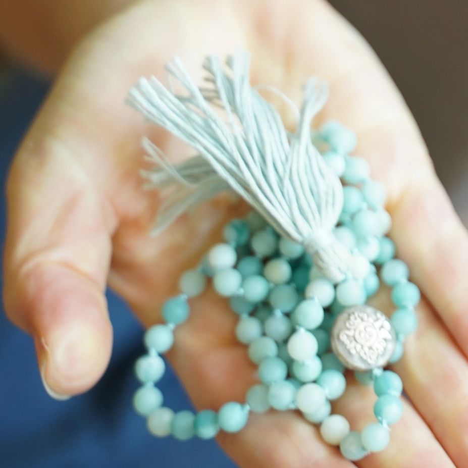 hand holding mala beads
