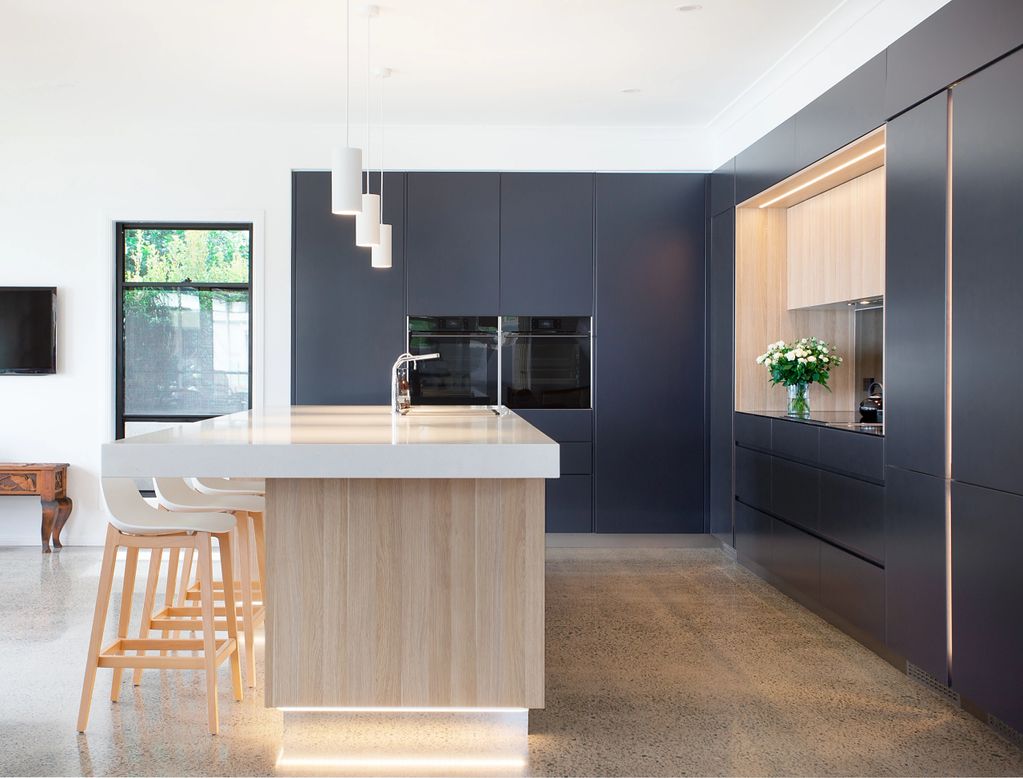 Contemporary kitchen with integrated appliances and large island benchtop 