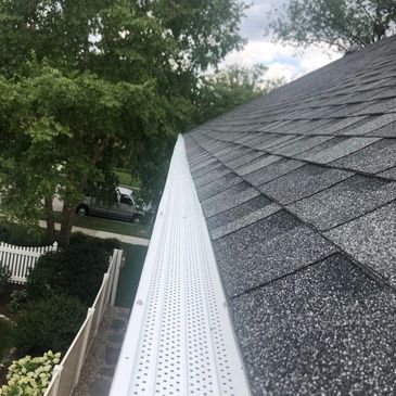 White micro-mesh gutter guard installed along a shingle roof edge in Algonquin, IL