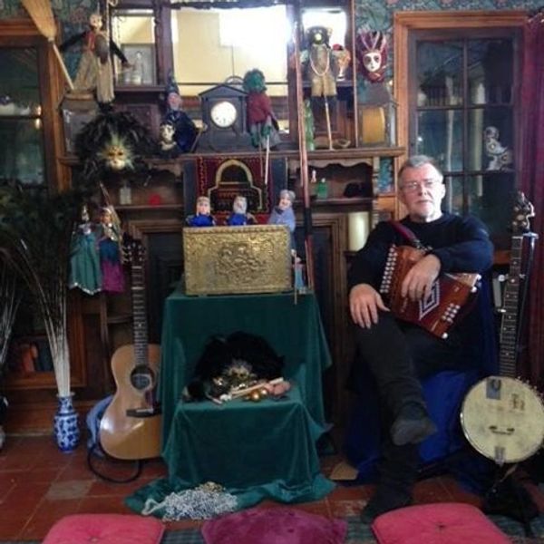 a man next to a lot of music instruments