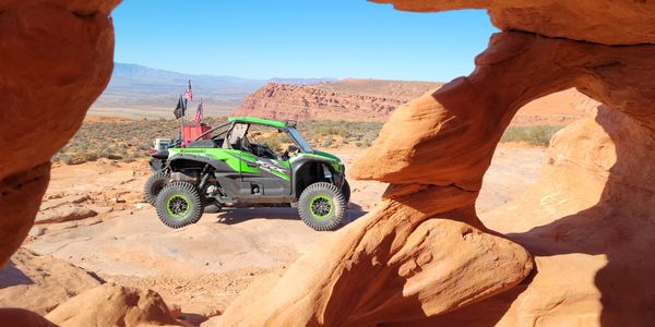 Viewing a KRX through a hole in sandstone formation at Sand Hallow, Utah.