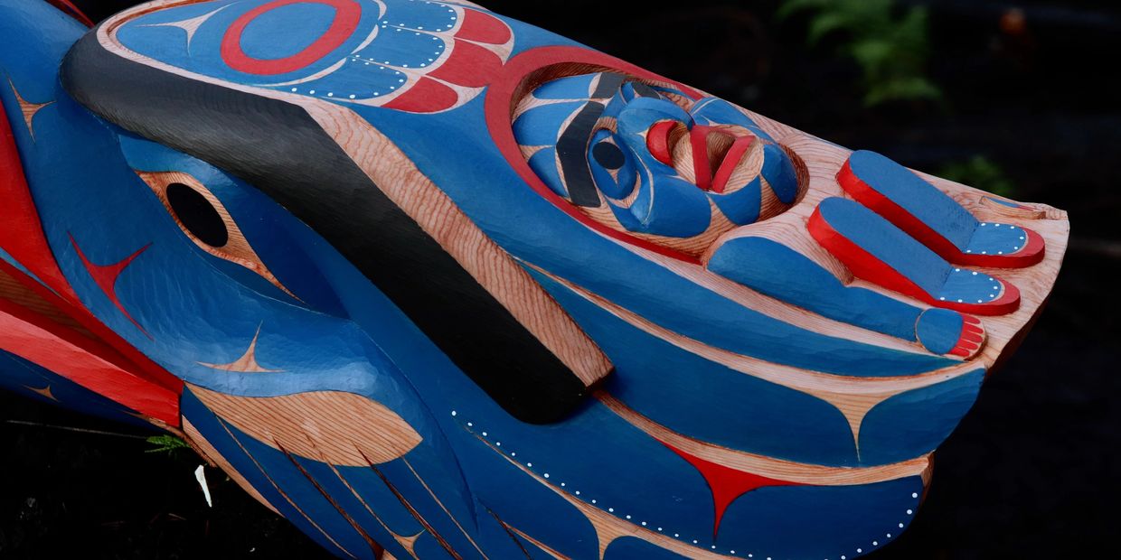 Colorful indigenous wooden carving with blue and red paint.