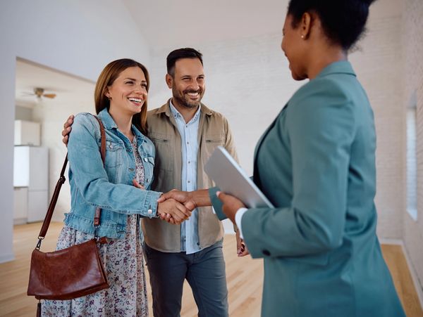 Real estate agent greeting clients