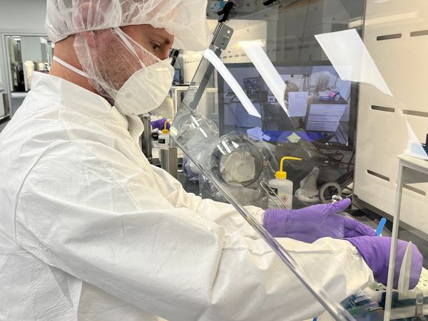 Pharmacist compounding inside of a powder hood