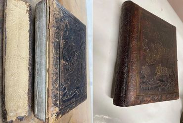 Antique leather book restoration with expert repair and preservation of original cover details.
