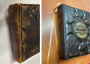 Antique book restoration with repaired spine, preserved cover, and ribbon marker.