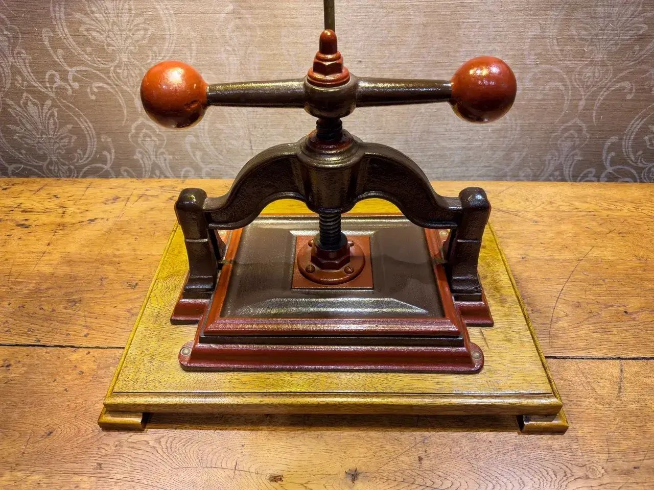 A traditional wooden bookbinding press used for handmade bookbinding and book restoration.
