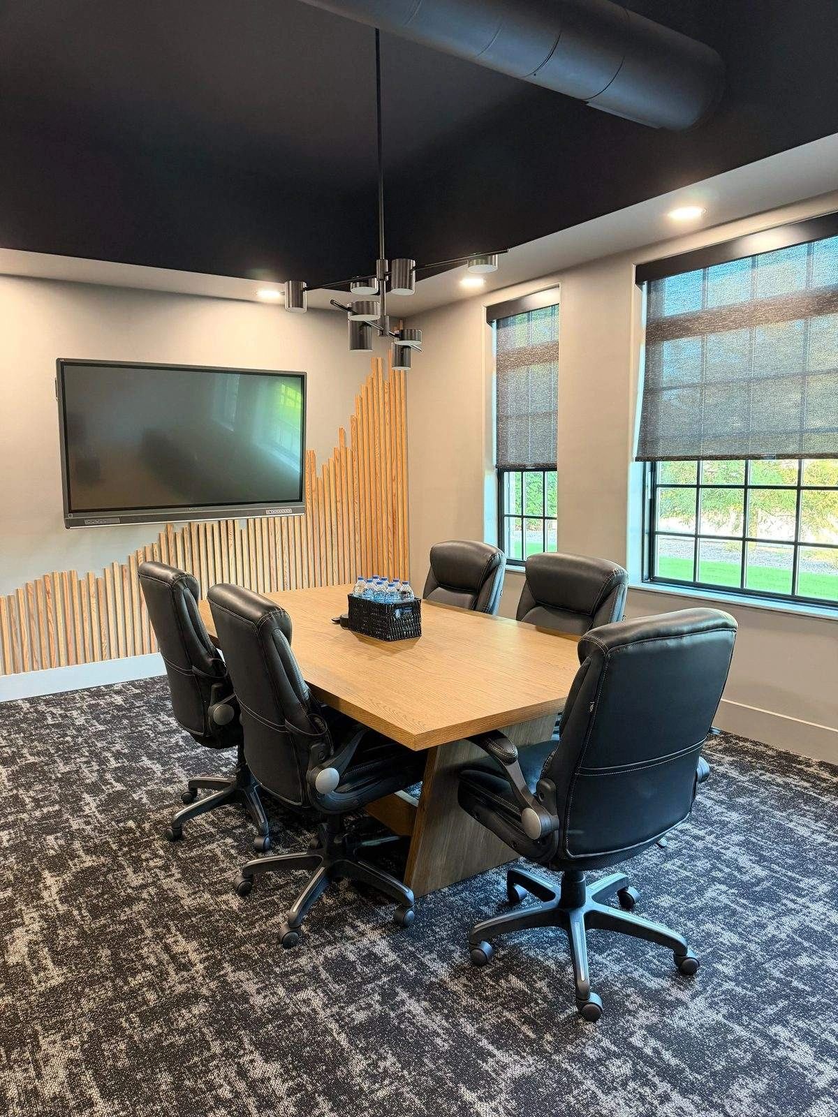 Office conference room with meeting table and display screen cleaned in Cumming, GA