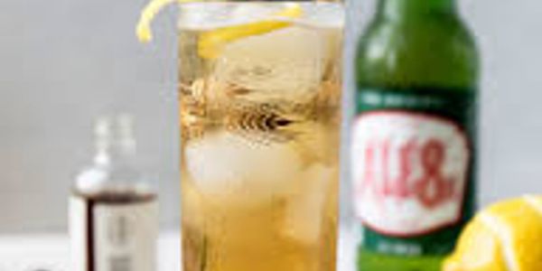 Iced ginger beer with lemon and tonic on a table.