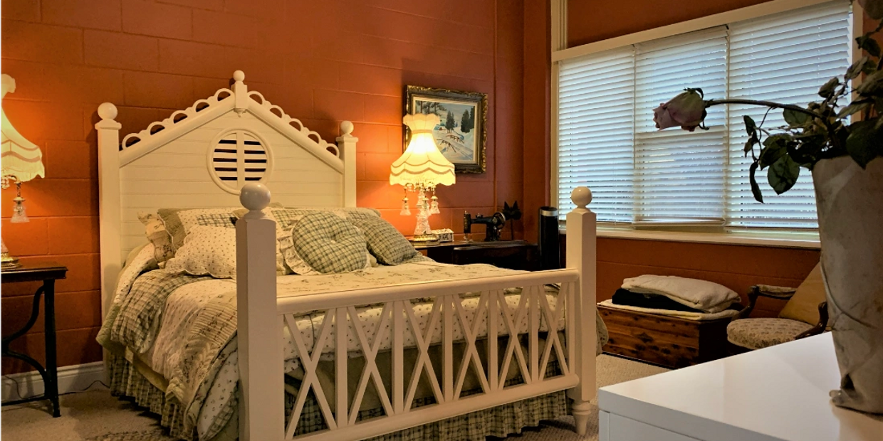 a wooden bed and antique lamps
