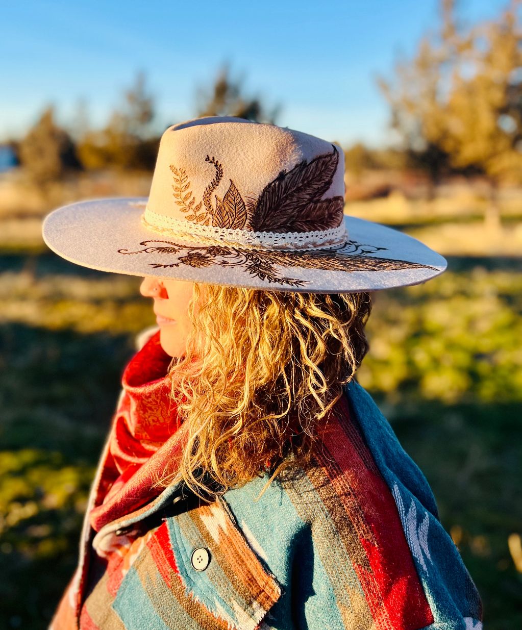 Customer asked for a silver belly flat brim with feathers and vines. 