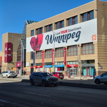 Downtown Winnipeg with a large 'Love Your Downtown Winnipeg' sign.