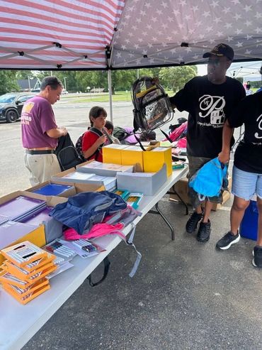 Children grabbing supplies for school