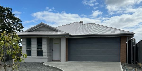 Modern single-story house with gray exterior and double garage.