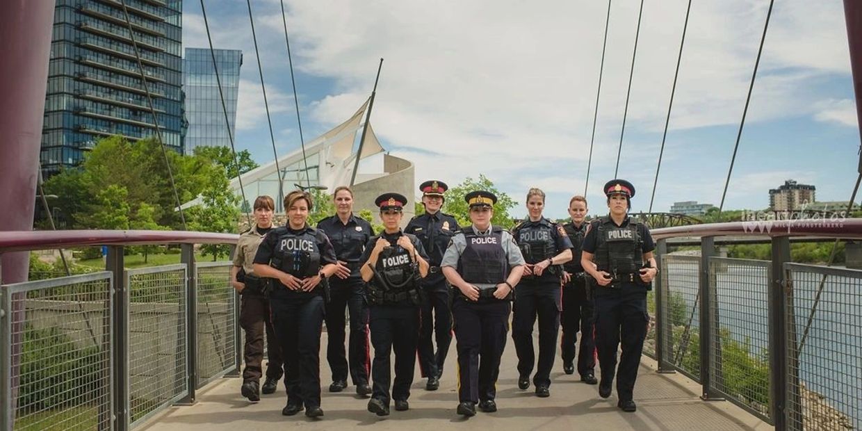 Group of police officers walking on a bridge.