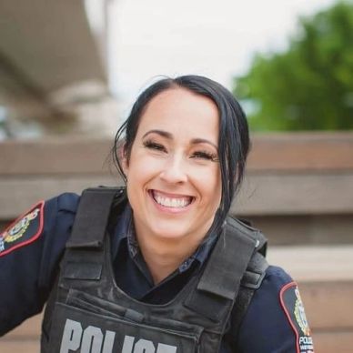 Smiling female police officer in uniform.