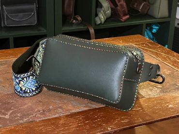 Dark green leather waist bag with colorful strap