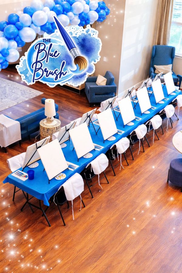 A painting setup with blank canvases and blue decorations.