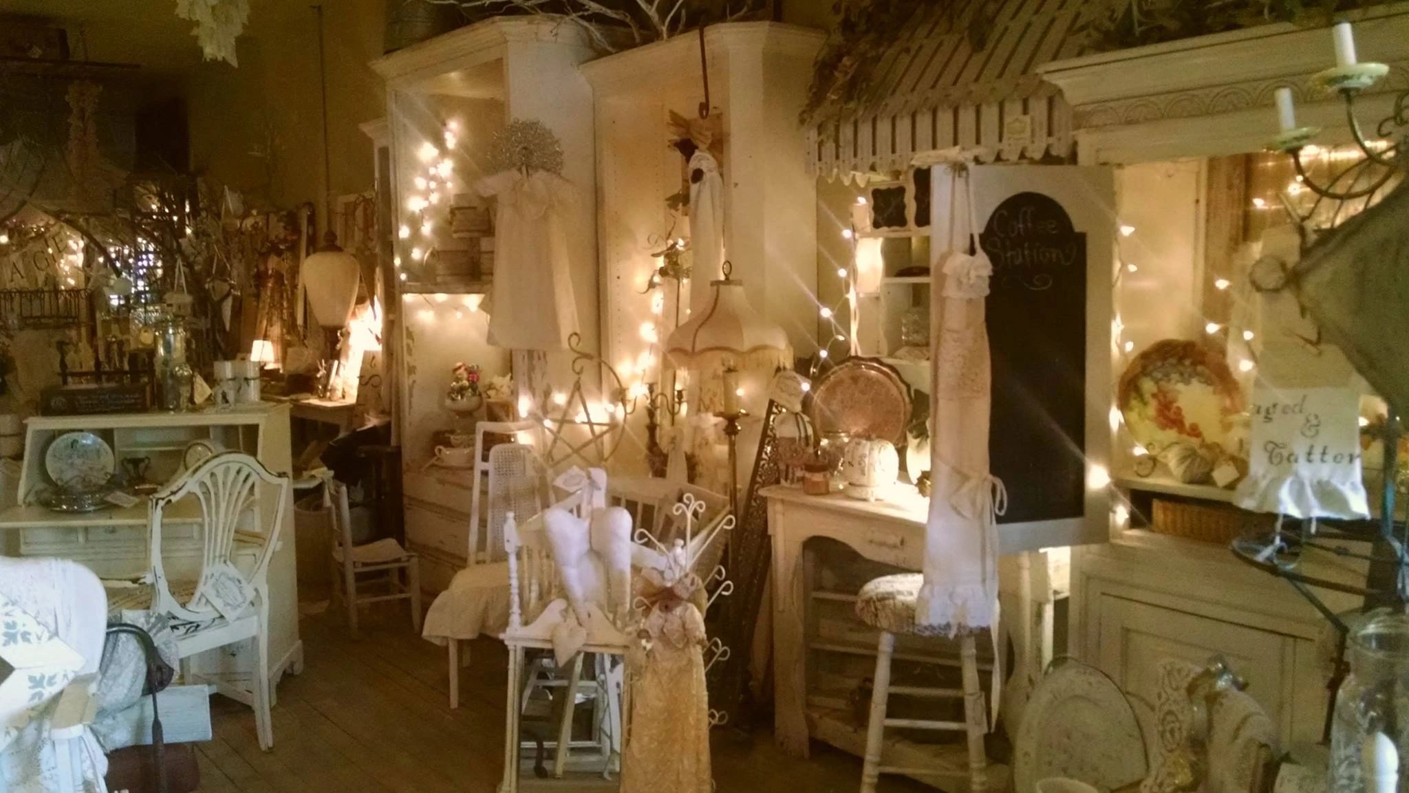 Cozy vintage shop decorated with warm string lights and antique furniture.