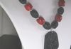 EE-152 Black Dragon: Carved Dragon Pendant (Jade?): strung with Apple Coral and Natural Black Lava Stone Beads. $85