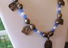 EE-243 Shiva in Blue Light: Five Antique Amulets from Rajasthan, India strung with White Rice Pearls and Blue Glas Beads, accented with metal Ethiopian Prayer Beads. $85