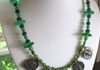 EE-248 Green Glory: Five Antique Amulets from Rajasthan India celebrating Shiva, strung with Green Glass Trade Beads from Asia and accented with old Ethiopian Green Vaseline Beads. $85