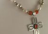 EE-325 Orange Zuni: Zuni-stamped Sterling Silver Cross signed with "J", strung with South Sea White Baroque Fresh Water Pearls, accented with old Orange Glass Beads from Nepal and four Vintage Sterling Silver Beads. $85