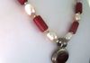 EE-416 Mexican Cherry: Vintage Mexican Sterling Silver Pendant with Red Stone, strung with White South Sea Pearls and Red Beads. $85