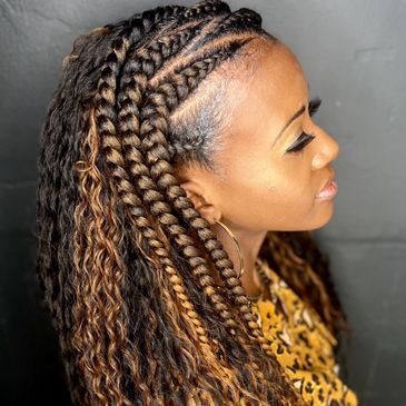 Woman with detailed braided and curly hairstyle.