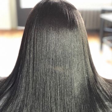 Smooth, shiny, straight black hair from the back view.