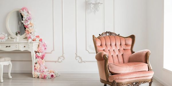 elegant powder room background. vintage mirror desk. comfy pink chair