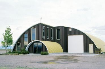 Modern arched building with yellow entry
