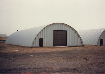 Wide shot of arched metal storage building