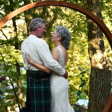 Deb and Joel at their wedding on the farm in front of the moon gate.