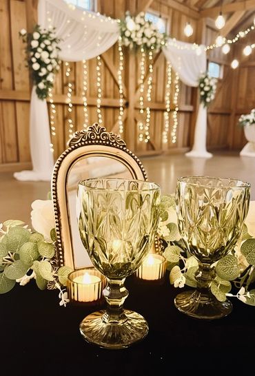 Elegant wedding table setup with vintage goblets and floral decorations.