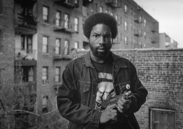 Black and white portrait of a man holding a gun