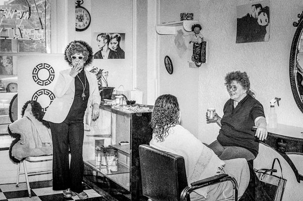 Women socializing in a vintage salon setting.